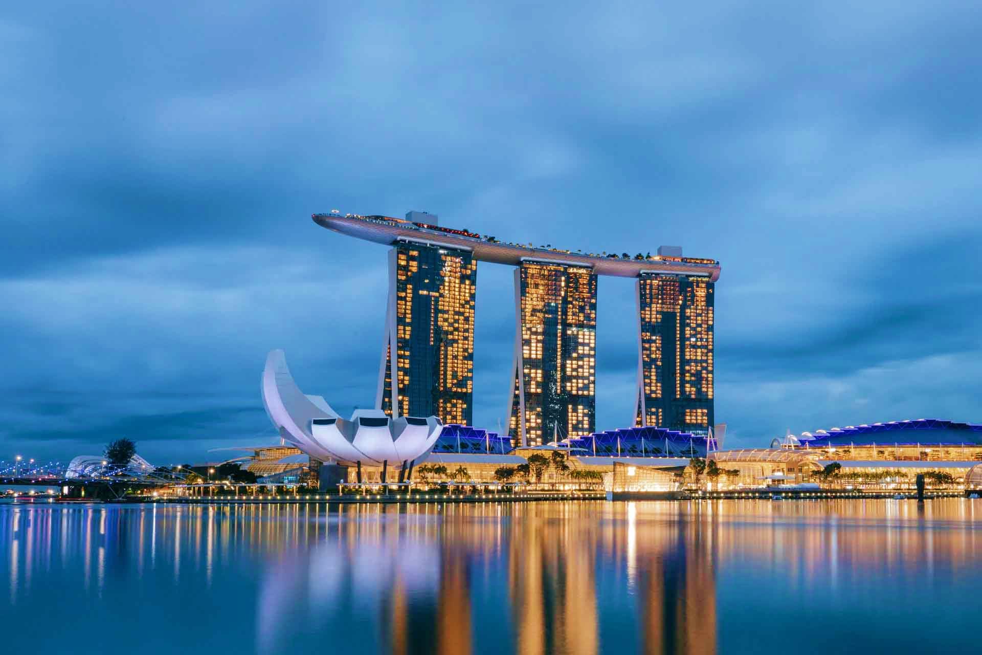 Marina Bay Sands hotel and resort illuminated at dusk with reflection in water, Singapore skyline